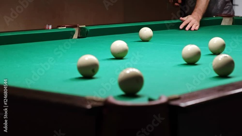 Wallpaper Mural Playing Russian or American billiards on a green pool table. A player hits the white ball with a cue successfully pockets another into a far corner pocket. Great hit. Pastime sport game hobby. 4K. Torontodigital.ca