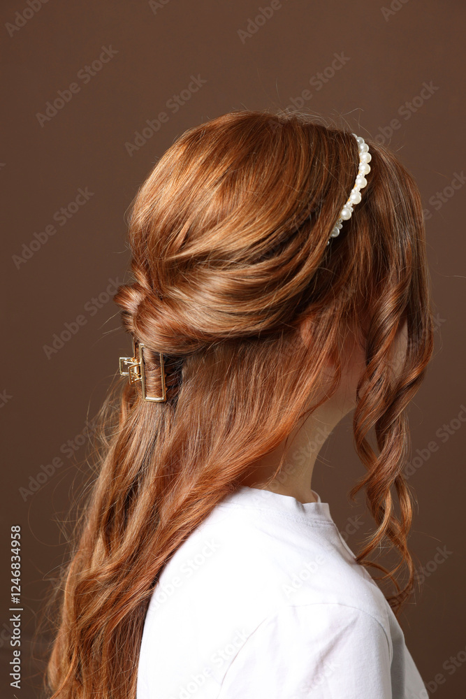 Teenage girl with stylish hair accessories on brown background, back view Teenage girl with stylish hair accessories on brown background, back view