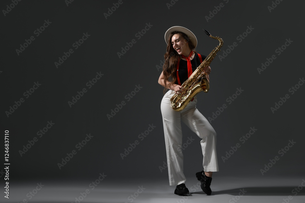 Naklejka premium Professional musician with saxophone on grey background. Space for text