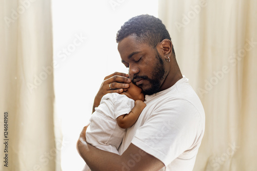Konstfotografi Caring black father with his newborn baby girl at home
