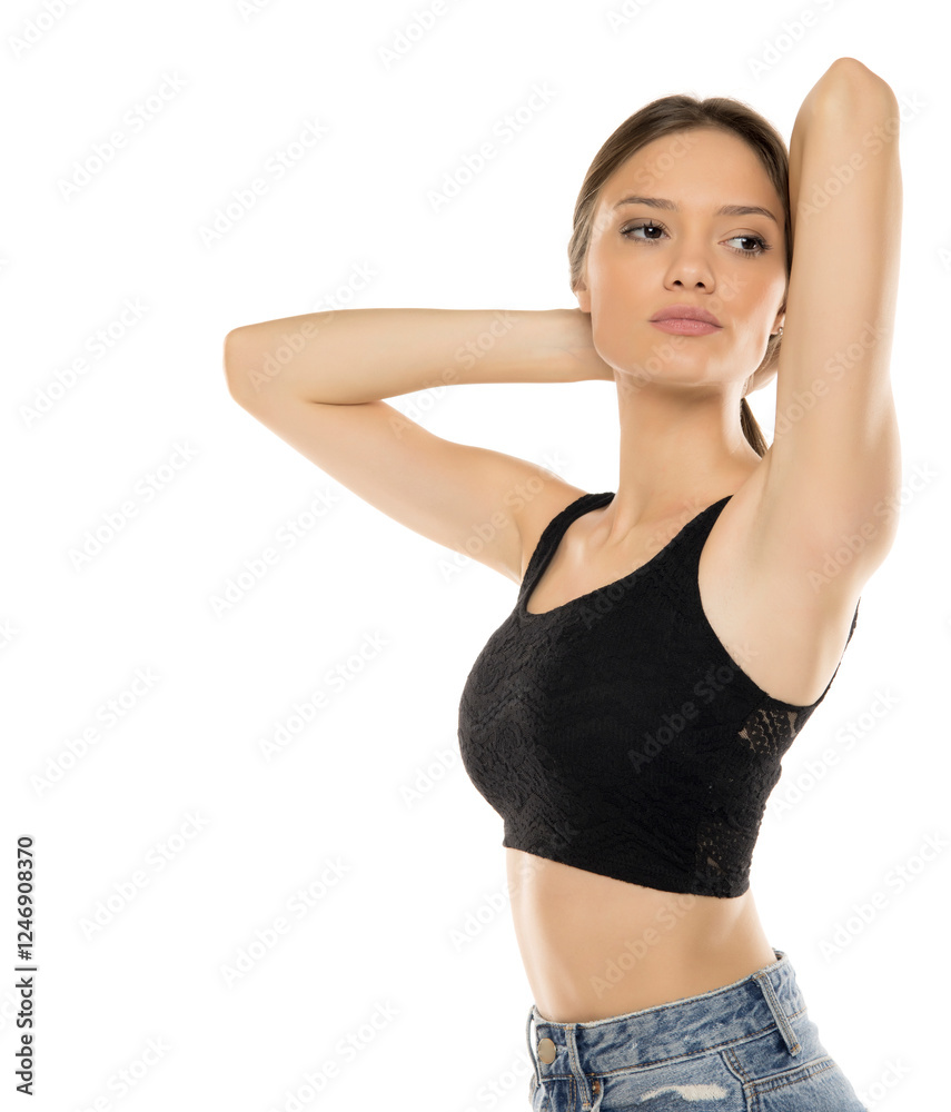 Professional studio portrait of young woman in black lace crop top against white background. Natural makeup and confident expression create modern fashion aesthetic Professional studio portrait of young woman in black lace crop top against white background. Natural makeup and confident expression create modern fashion aesthetic