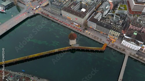 Kapellbruecke und Wasserturm Luzern, Schweiz Luftaufnahme bei nebligem Fruehjahrswetter. Chapel Bridge and Water Tower in Lucerne, Switzerland aerial view in foggy spring weather. Lucernes landmark.  photo