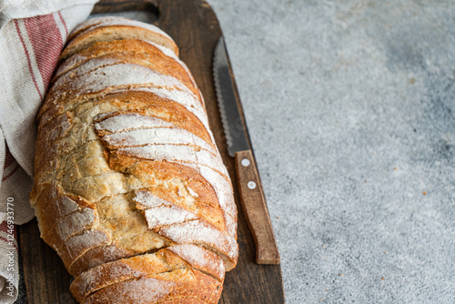 Close-up of Freshly sliced  homemade  white sourdough loaf on a wooden chopping board photo