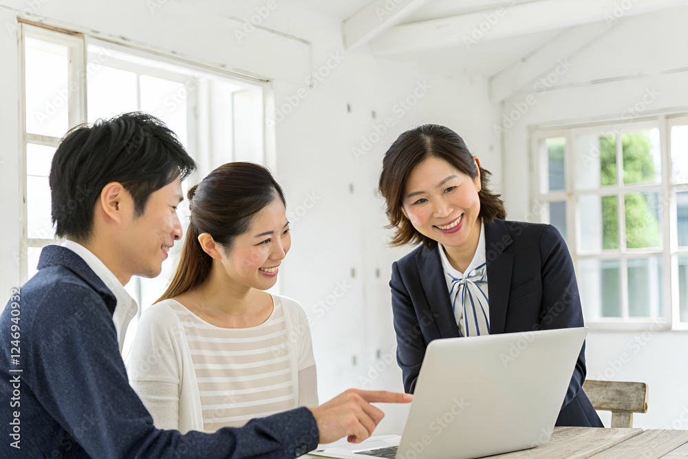 A group of three professionals engaged in a collaborative discussion around a laptop, sharing ideas and insights in a bright, modern workspace. A group of three professionals engaged in a collaborative discussion around a laptop, sharing ideas and insights in a bright, modern workspace.