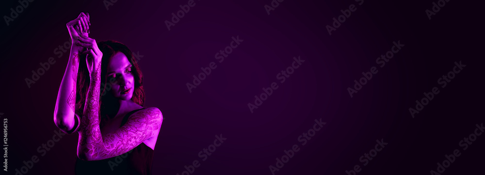 Obraz premium Beautiful woman with tattoos on arms in neon light, space for text. Banner design