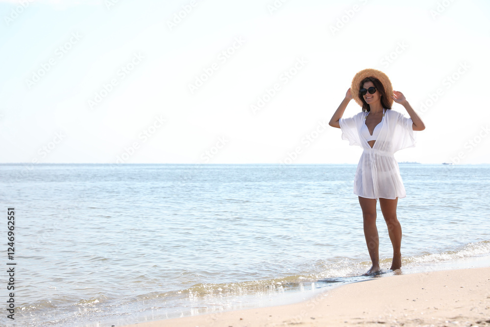 Young woman with beautiful body on sandy beach. Space for text Young woman with beautiful body on sandy beach. Space for text