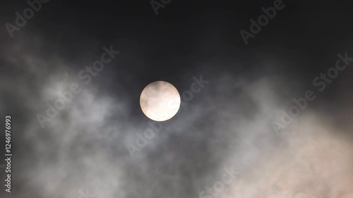 Cloud cover passes over the sun creating a captivating sight in the sky at midday