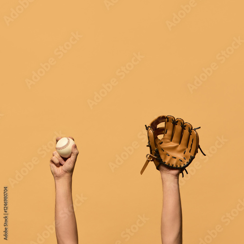Canvas Print Raised hand in leather baseball glove, and gripping ball, symbolizing defensive preparation and teamwork against warm-toned background