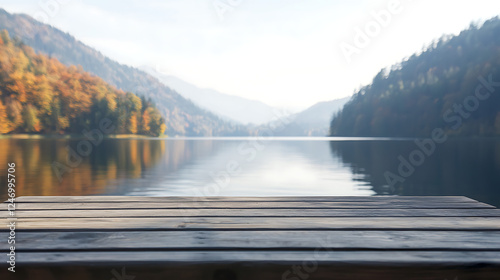 A wooden dock overlooking a lake with mountains in the background photo