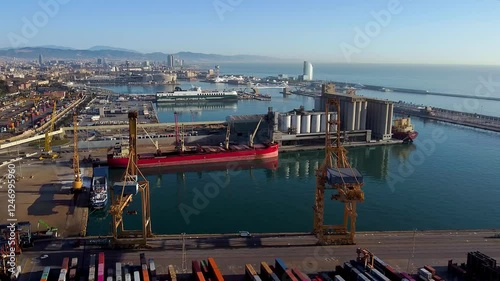 Barcelona, Spain - 3 February 2025: Aerial view of shipping containers and cargo ships in the sea port. Concept of sea and maritime trade and trade war due to tariffs. Commercial hub