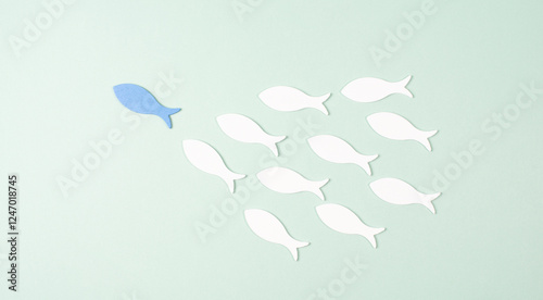 Blue fish leader of group, teamwork, follow influencer, goal, plan and strategy for success, leadership concept