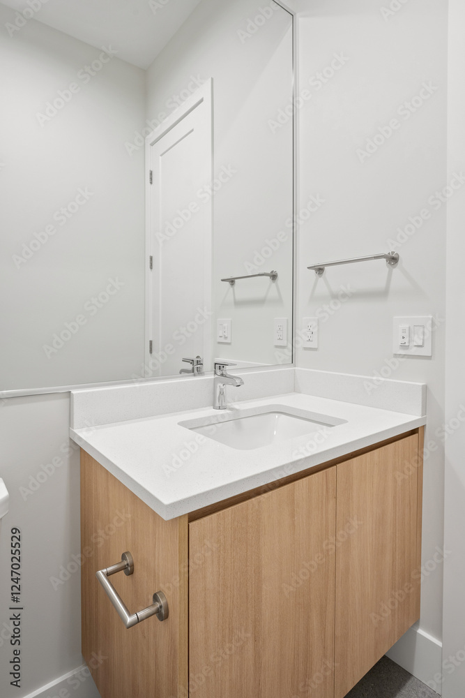 A bathroom sink with a wooden cabinet underneath A bathroom sink with a wooden cabinet underneath