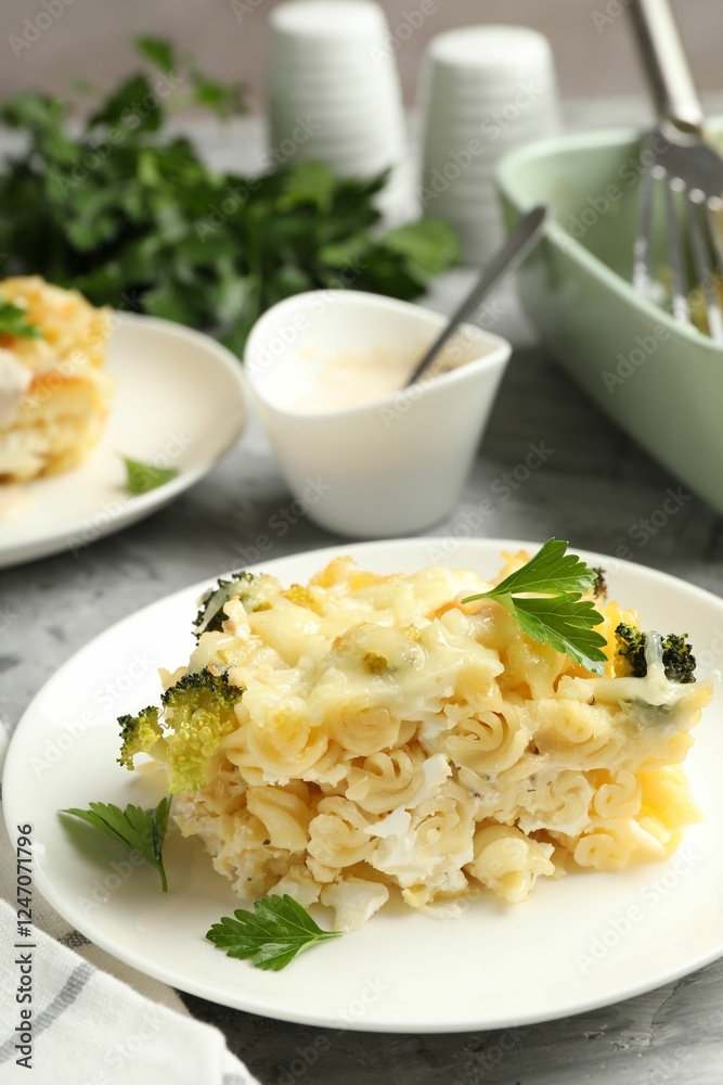 Tasty pasta casserole with cheese and broccoli served on grey table, closeup Tasty pasta casserole with cheese and broccoli served on grey table, closeup