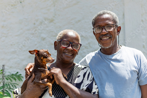 Obraz na plátně Happy elderly couple smiling on a light background