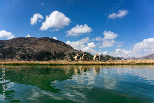 Floating Uros Islands in Lake Titicaca, Peru with Beautiful Reed Houses and Scenic Views of the Surrounding Andes Mountains photo