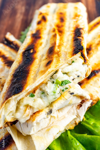 Wallpaper Mural Delicious grilled wraps filled with cheese and herbs on a wooden surface Torontodigital.ca