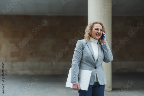 Professional woman engaging in business call outdoors