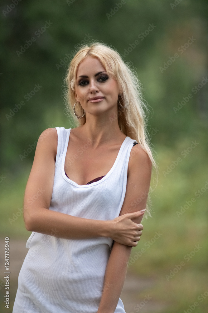 Portrait of a beautiful blonde girl in nature in summer. Portrait of a beautiful blonde girl in nature in summer.
