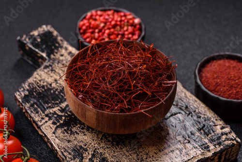 Fototapeta Naklejka Na Ścianę i Meble -  Red thin hot chili threads on a dark background