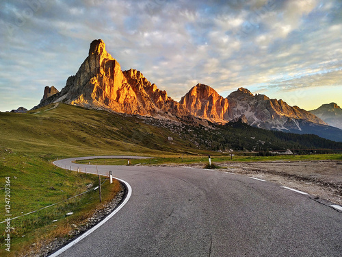 Dolomites mountains sunrise. Scenic mountain road in Dolomites, Italy
