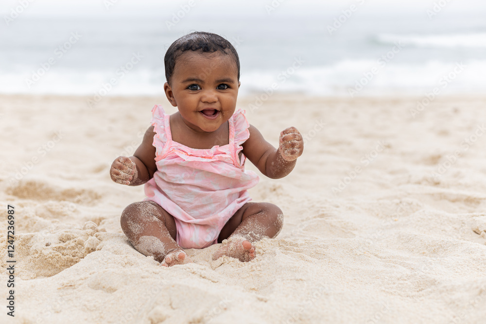 Happy baby girl on her first time at the beach playing. Rio de Janeiro, Brazil. Happy baby girl on her first time at the beach playing. Rio de Janeiro, Brazil.