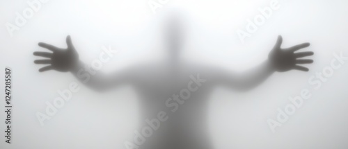 A person stands in a foggy environment, arms extended wide, creating a mysterious silhouette