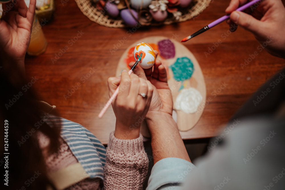 Fototapeta premium Hands creating colorful easter egg art