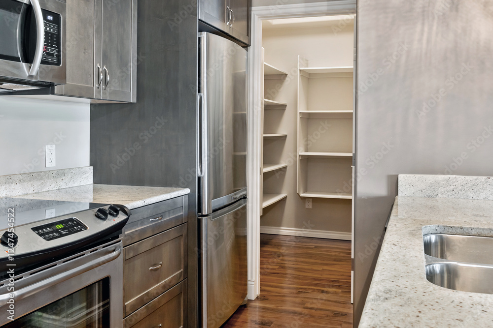Fototapeta premium A kitchen with a stainless steel refrigerator and microwave