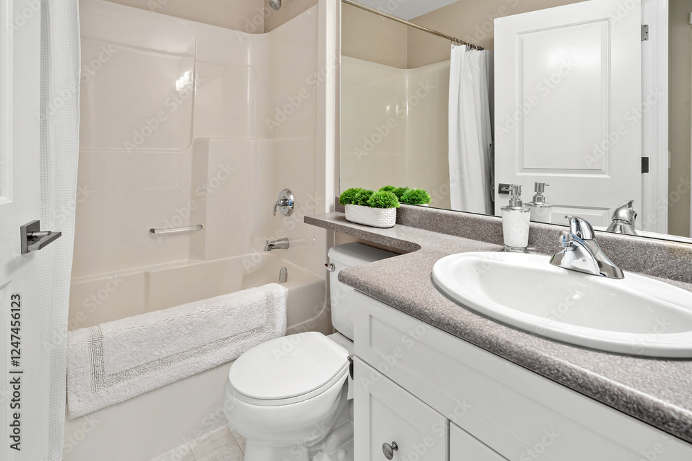 A bathroom with a white toilet, sink, and bathtub A bathroom with a white toilet, sink, and bathtub