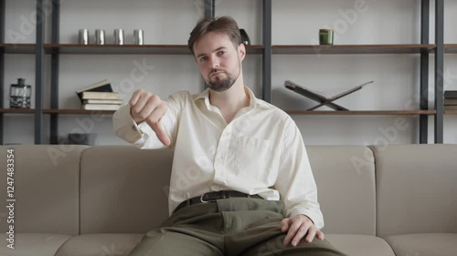 Sad Young Businessman Looking Camera Showing Thumb Down