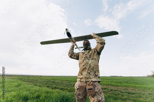 unmanned aerial vehicle in the hands of a soldier. Launching a drone for reconnaissance purposes