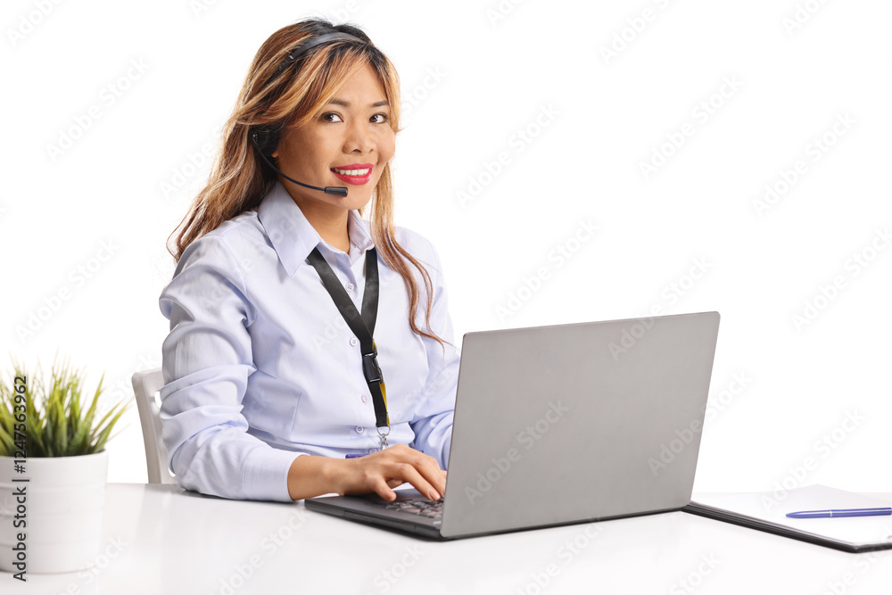 Asian woman working on a laptop computer with wireless handsfree headphones Asian woman working on a laptop computer with wireless handsfree headphones