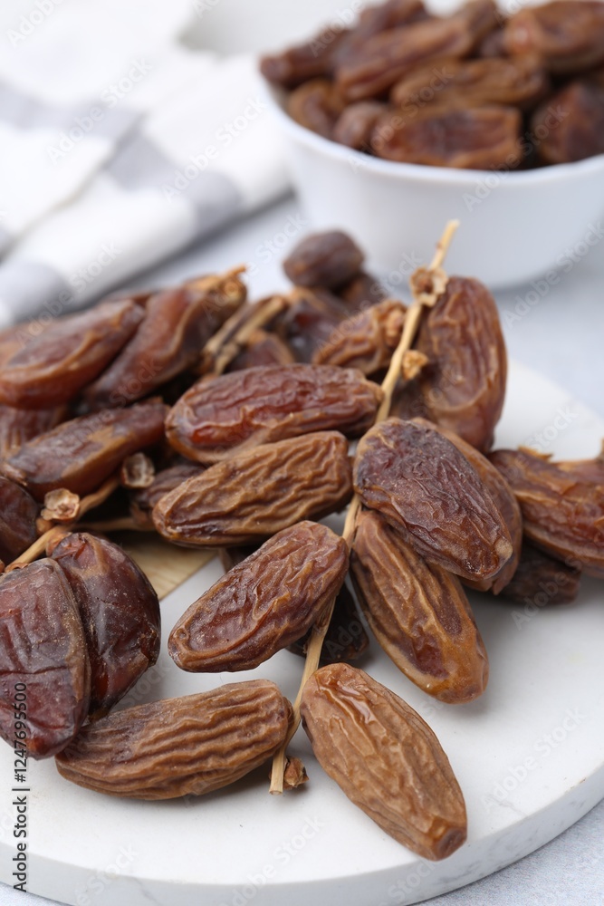 Tasty dried dates on light table, closeup Tasty dried dates on light table, closeup