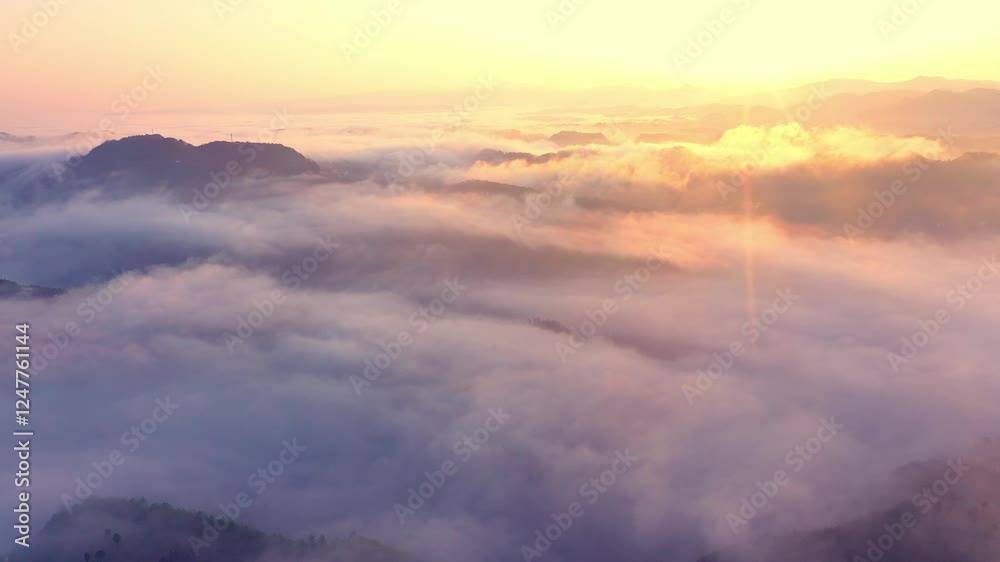 Majestic aerial views of mountains surrounded by a sea of clouds at sunrise Majestic aerial views of mountains surrounded by a sea of clouds at sunrise