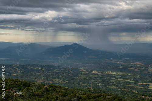 Aerial panoramic wide angle view of heavy dark clouds and rainstorm over mountain landscape, shot from a lookout located between small towns Berlin and Alegria in El Salvador. Severe weather concept. photo