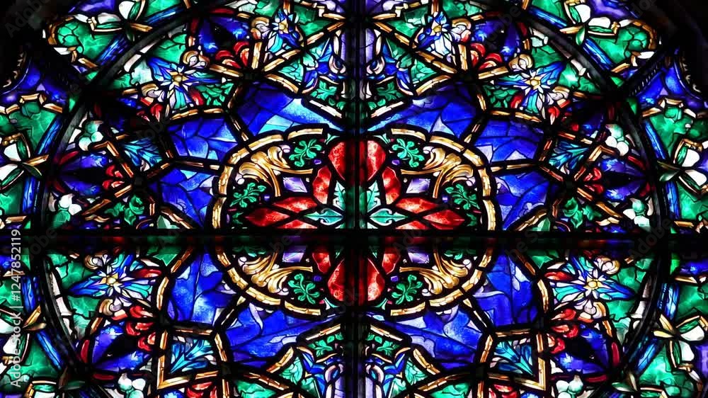 A stunning stained glass window displays a blend of rich colors and detailed patterns, illuminating the interior of a historic church during daylight hours. A stunning stained glass window displays a blend of rich colors and detailed patterns, illuminating the interior of a historic church during daylight hours.