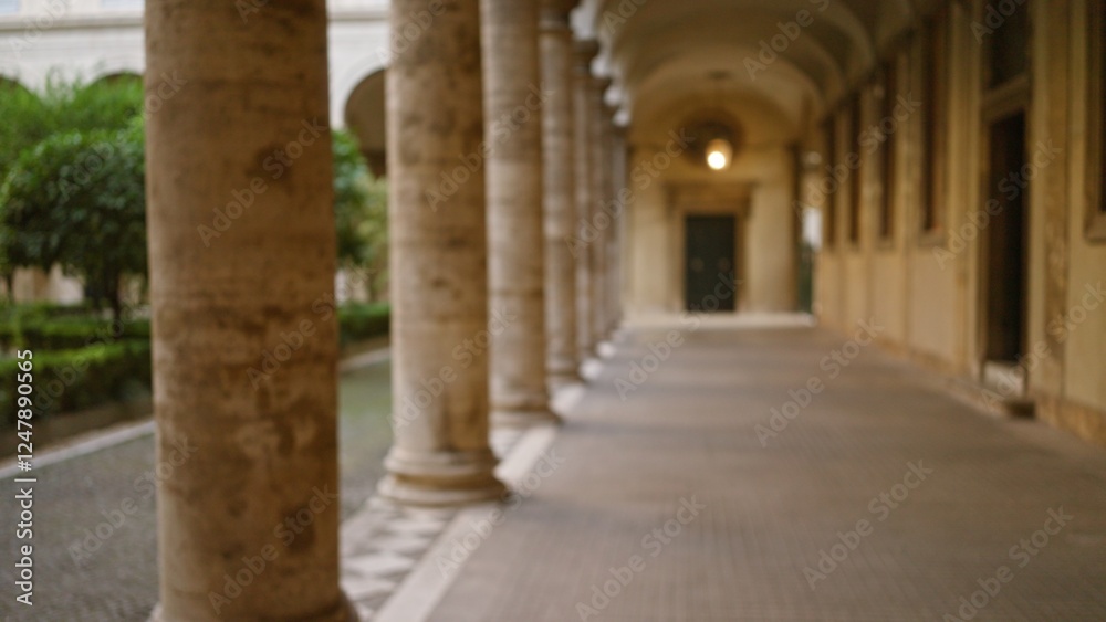 Blurred view of old university campus outdoor hallway with stone columns creating a classic academic atmosphere, enhanced by soft bokeh and defocused background. Blurred view of old university campus outdoor hallway with stone columns creating a classic academic atmosphere, enhanced by soft bokeh and defocused background.