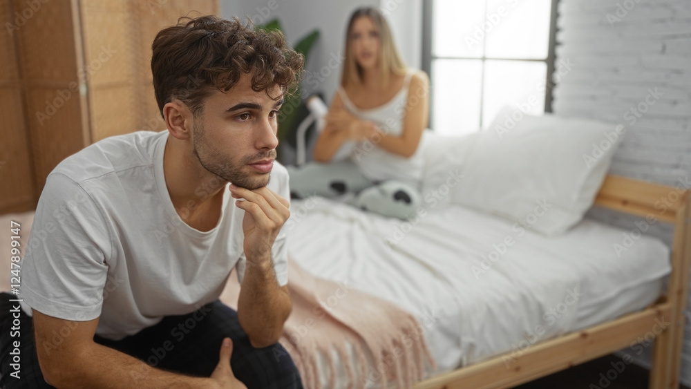 Obraz premium Man and woman in bedroom discussing relationship while seated on bed at home interior, with thoughtful expressions suggesting contemplation and communication.