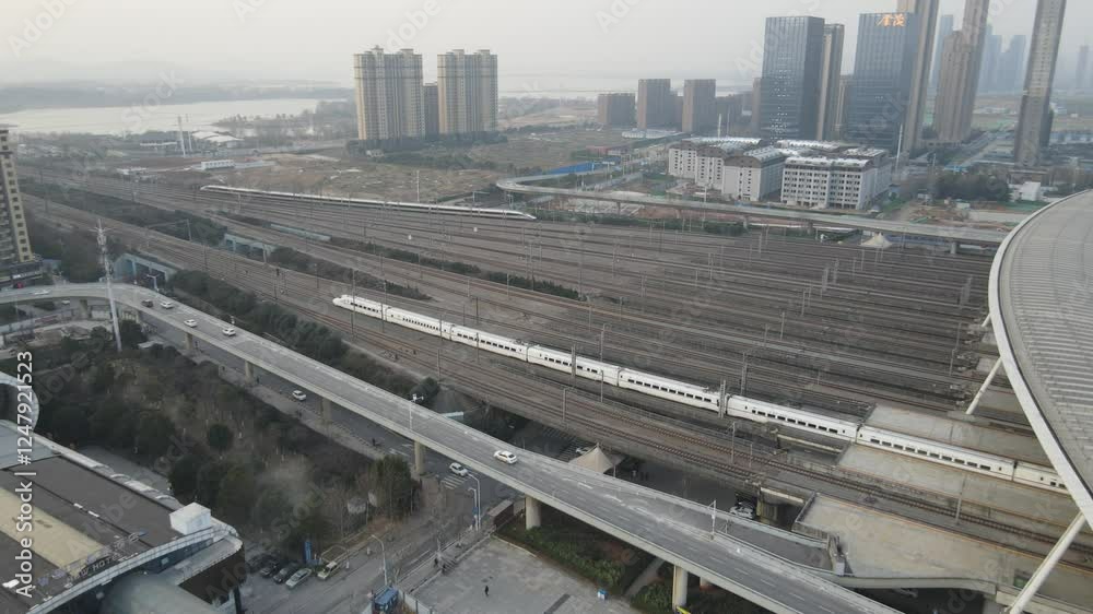 High speed train arrives at bustling station with urban landscape in the background during daylight hours High speed train arrives at bustling station with urban landscape in the background during daylight hours
