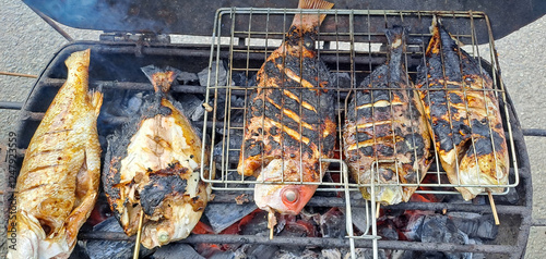 cooking fish on grill	
