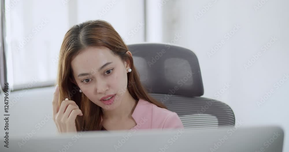 A woman in an office thoughtfully considers solutions to challenges in a contemporary workspace. A woman in an office thoughtfully considers solutions to challenges in a contemporary workspace.