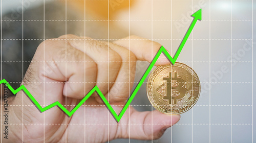 Hand Holding Bitcoin with Upward Trend Chart