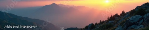 Gentle morning glow illuminates rugged terrain, dawn, misty, mountain