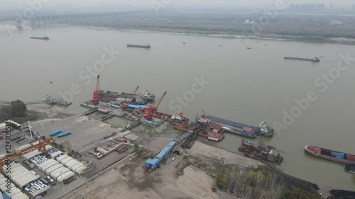 Cargo terminal operations at Qingshan District in Wuhan with aerial perspective showcasing unloading machinery