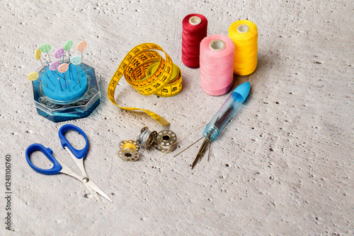 sewing tools and accesories blurred concrete background and copy space photo