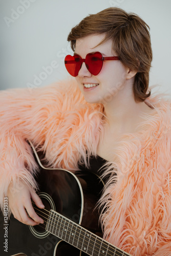 A young woman wearing heart-shaped glasses plays an acoustic guitar, radiating creativity and joy. The image captures her passion for music, inspiration, and the artistic vibe of a modern musician