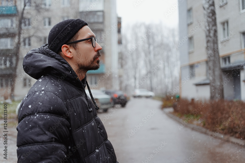 A young man in casual style walks through the snowy city on a winter day, chatting on his phone and sipping coffee. The lifestyle photo captures his relaxed, modern vibe and cheerful energy A young man in casual style walks through the snowy city on a winter day, chatting on his phone and sipping coffee. The lifestyle photo captures his relaxed, modern vibe and cheerful energy