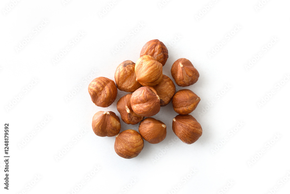 Heap of shelled hazelnuts isolated on white table Heap of shelled hazelnuts isolated on white table