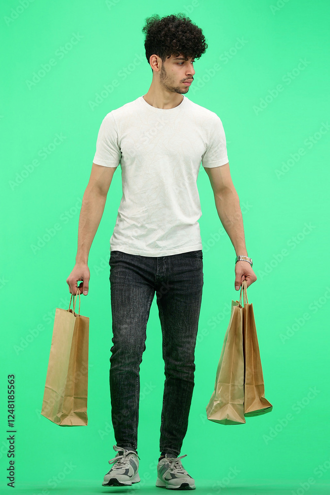 Man, on a green background, full-length, with bags Man, on a green background, full-length, with bags