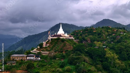 06 Mahamevnawa Buddhist Monastery on a hill surrounded by lush greenery and clouds photo